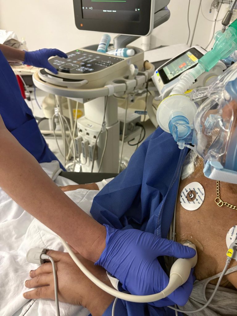 Médecin réalisant une échographie clinique (POCUS) au lit du patient pour évaluer l’état de déshydratation en urgence